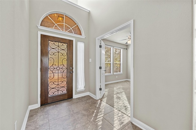 tiled foyer with ceiling fan