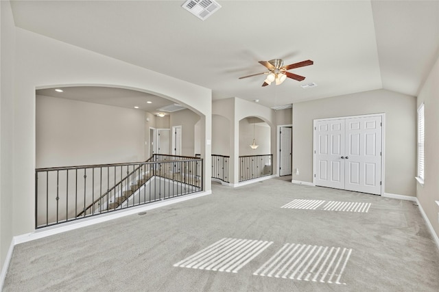 unfurnished room featuring lofted ceiling, light colored carpet, and ceiling fan