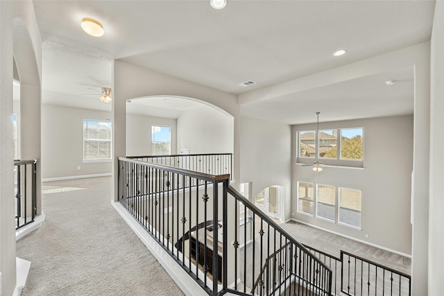 hallway with light colored carpet