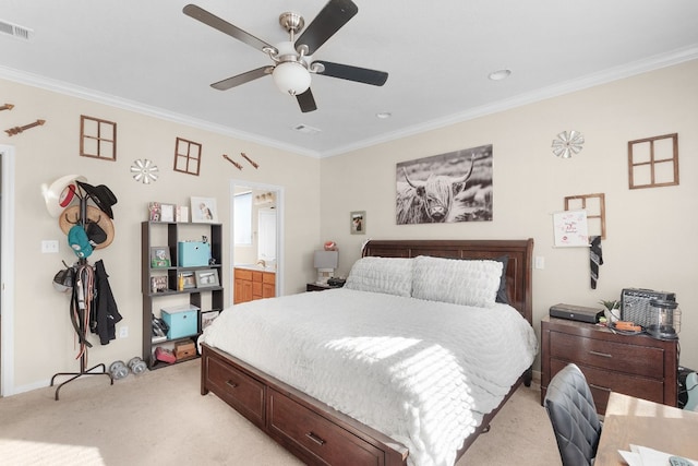 bedroom with ornamental molding, ensuite bathroom, light colored carpet, and ceiling fan