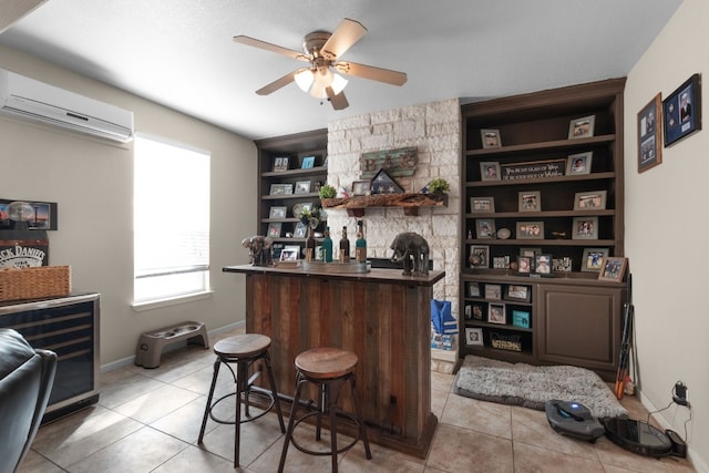 bar featuring a wall mounted air conditioner, built in features, ceiling fan, beverage cooler, and light tile patterned floors