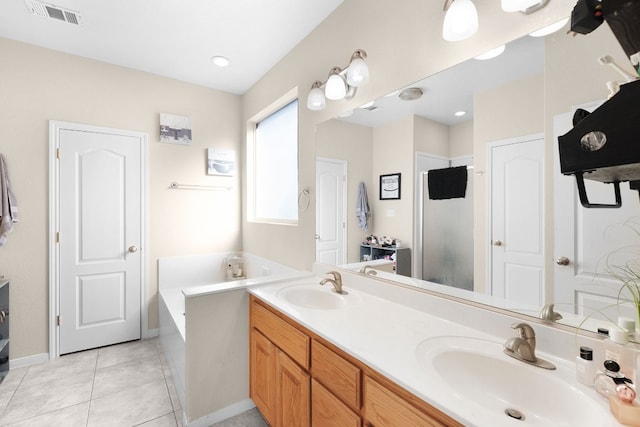 bathroom featuring vanity, tile patterned flooring, and a washtub