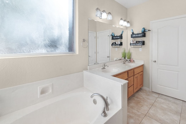 bathroom featuring vanity, tile patterned floors, and a bath