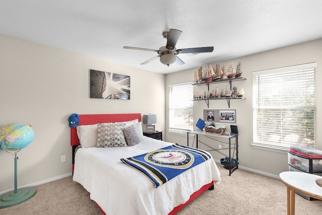 bedroom featuring carpet, a textured ceiling, and ceiling fan