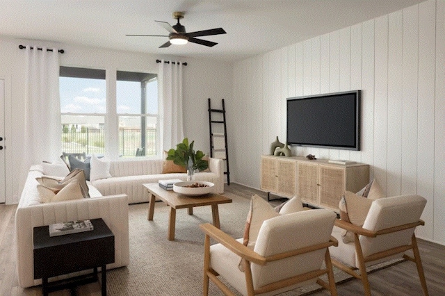 living room with wood-type flooring and ceiling fan