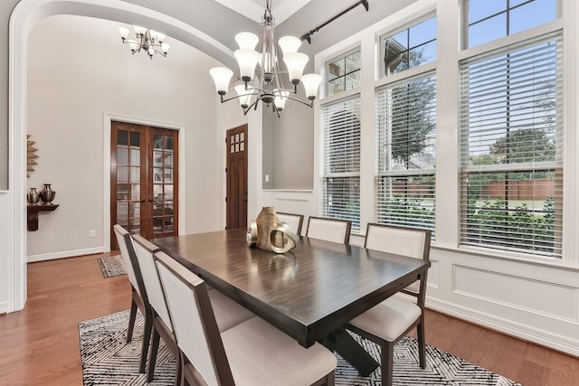 dining room featuring an inviting chandelier, french doors, and hardwood / wood-style floors