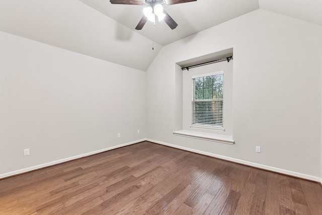 spare room with ceiling fan, vaulted ceiling, and hardwood / wood-style floors