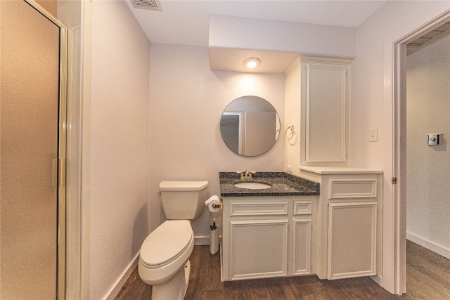 bathroom with hardwood / wood-style floors, vanity, and toilet