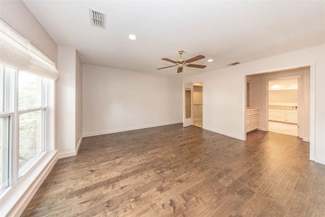 spare room featuring dark hardwood / wood-style flooring and ceiling fan