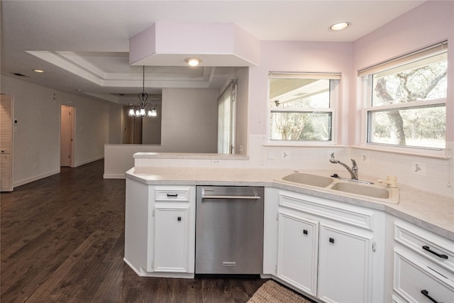 kitchen with dark wood-type flooring, white cabinetry, pendant lighting, and dishwasher