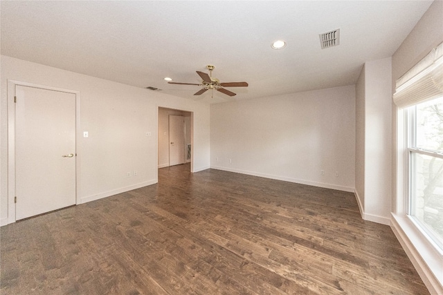 empty room featuring dark hardwood / wood-style flooring and ceiling fan