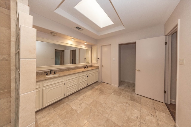 bathroom with vanity and a raised ceiling