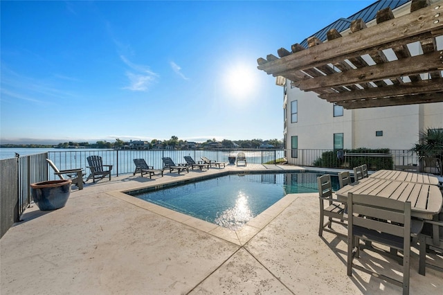 view of pool with a patio area, a water view, and a pergola