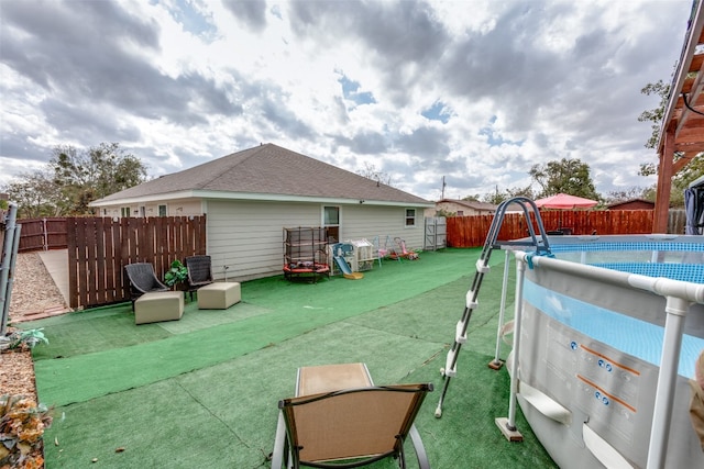 view of yard featuring a fenced in pool