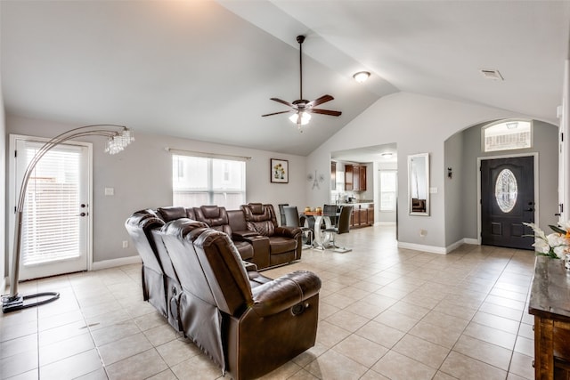 tiled living room featuring ceiling fan and lofted ceiling