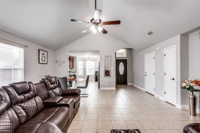 living room with lofted ceiling, plenty of natural light, light tile patterned floors, and ceiling fan