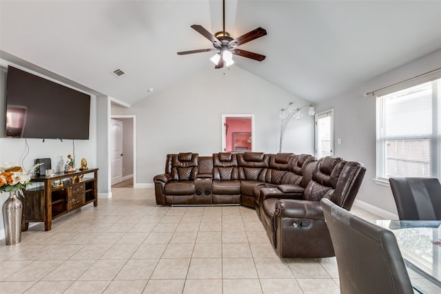 living room featuring lofted ceiling, light tile patterned flooring, and ceiling fan