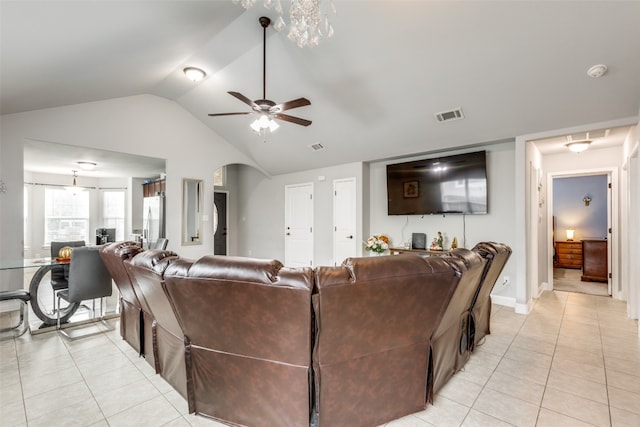 tiled living room with ceiling fan and vaulted ceiling