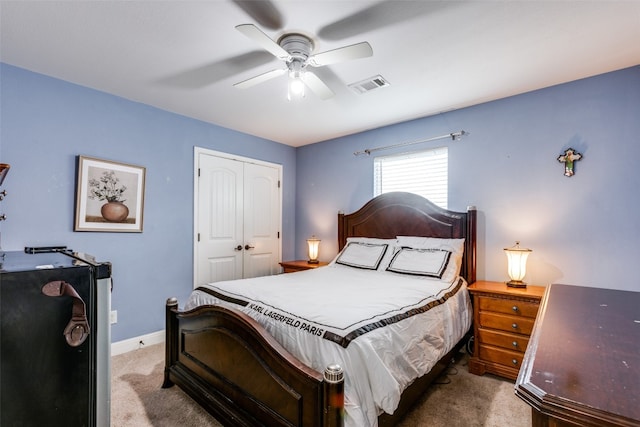 carpeted bedroom featuring a closet and ceiling fan