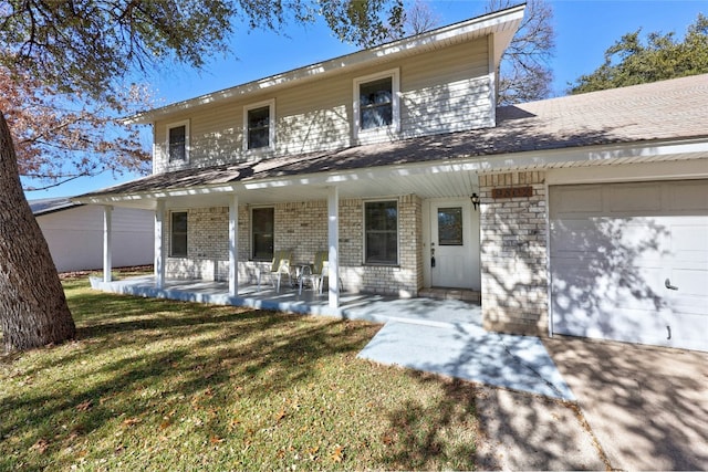 view of front facade featuring a porch, a garage, and a front lawn