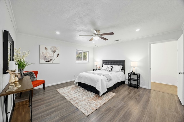 bedroom with a textured ceiling, ceiling fan, dark hardwood / wood-style floors, and crown molding