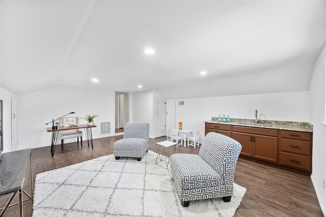 sitting room with hardwood / wood-style flooring, lofted ceiling, and sink