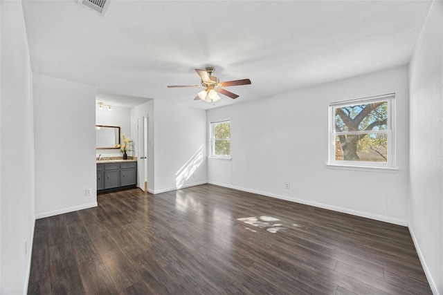 unfurnished living room featuring ceiling fan and dark hardwood / wood-style flooring