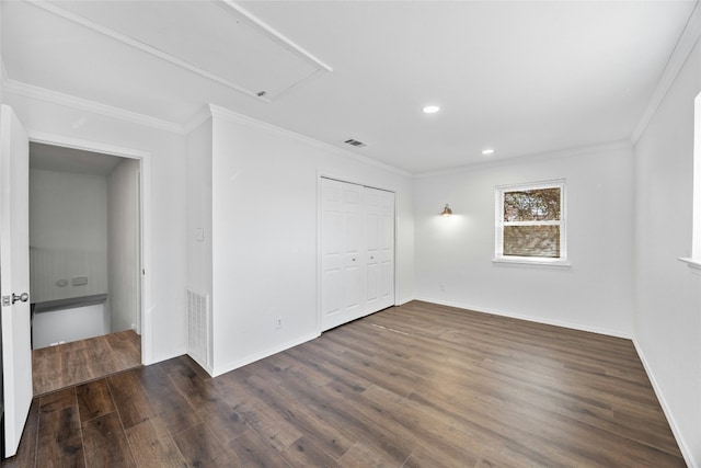 spare room featuring dark wood-type flooring and ornamental molding