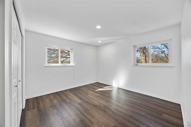 unfurnished bedroom with dark hardwood / wood-style floors and a closet