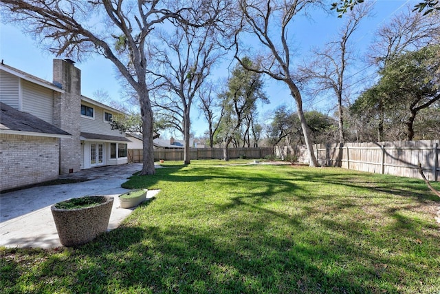 view of yard featuring french doors and a patio area