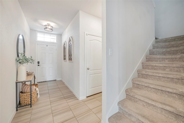 entryway with light tile patterned floors