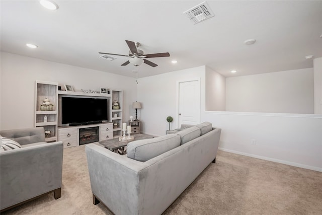 living room with ceiling fan and light carpet