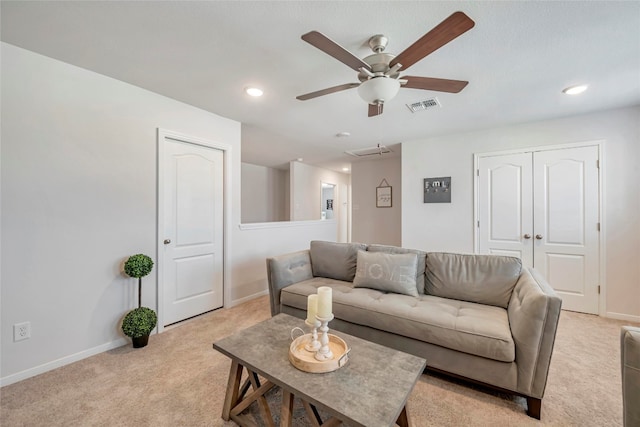 carpeted living room with ceiling fan