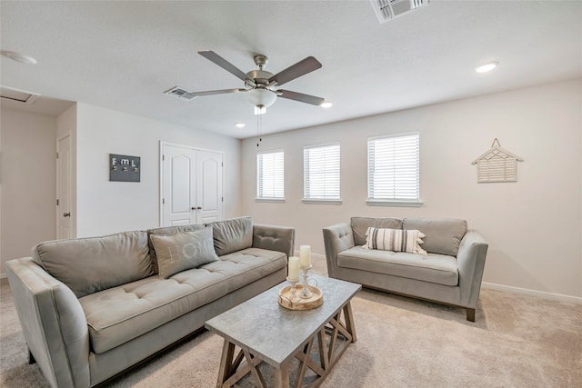 carpeted living room featuring ceiling fan