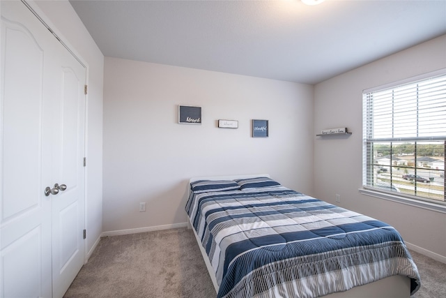 carpeted bedroom with a closet