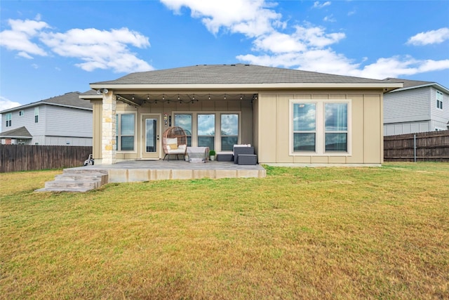 rear view of house featuring an outdoor living space and a lawn