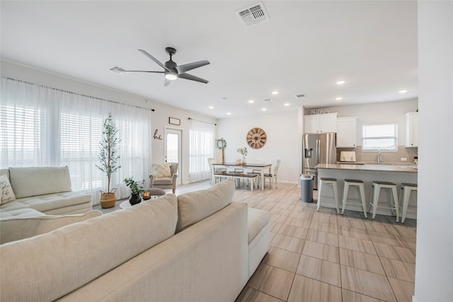 living room featuring sink and ceiling fan