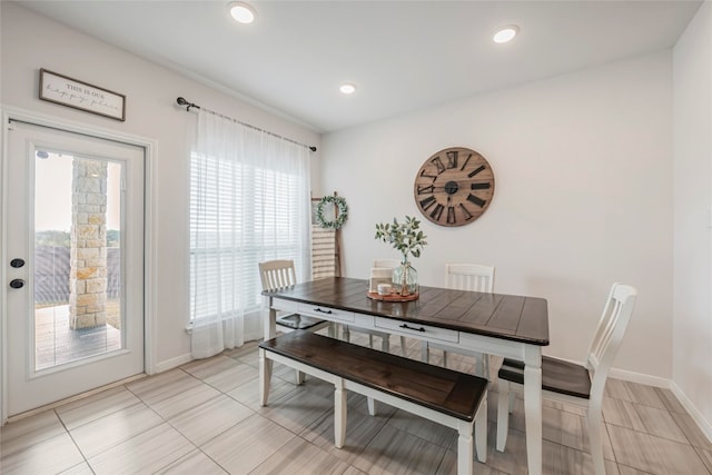 dining area featuring light tile patterned flooring and plenty of natural light