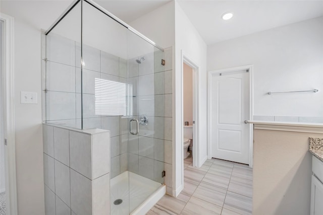 bathroom featuring vanity, toilet, and walk in shower