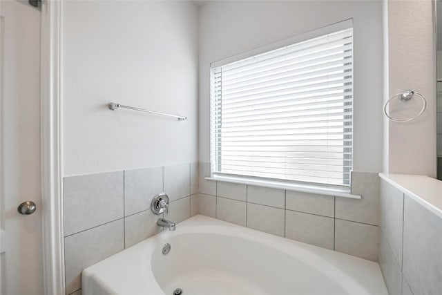 bathroom featuring a tub to relax in and plenty of natural light