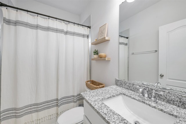 bathroom with vanity, a shower with curtain, and toilet