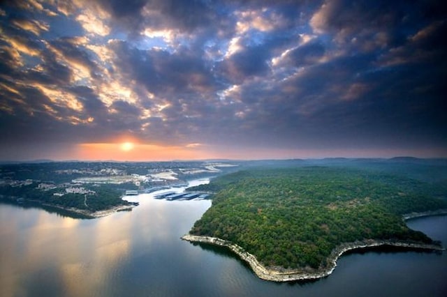 335 Lombardia Dr Unit 19E, Austin, TX 78734 - aerial view at dusk with a water view and a wooded view