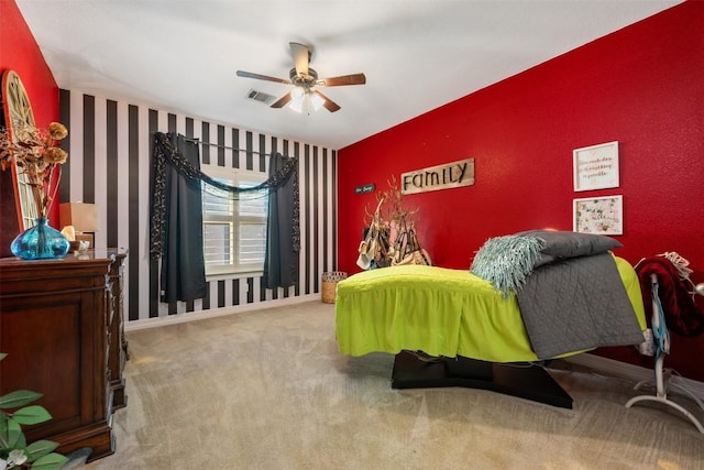 335 Lombardia Dr Unit 19E, Austin, TX 78734 - carpeted bedroom with an accent wall, a ceiling fan, baseboards, wallpapered walls, and visible vents