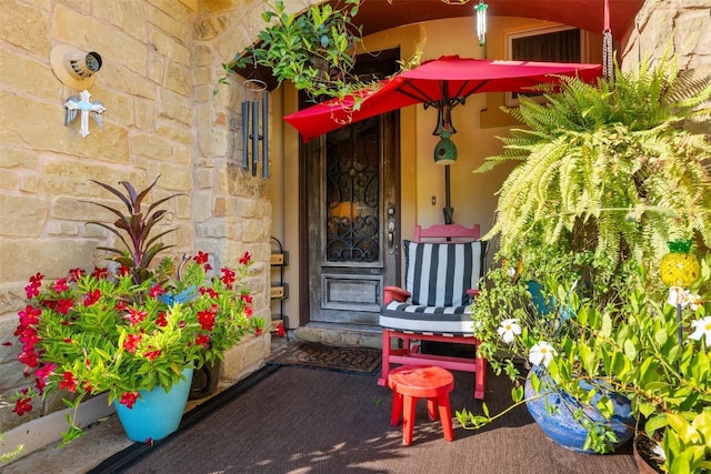 335 Lombardia Dr Unit 19E, Austin, TX 78734 - view of exterior entry with covered porch and stone siding