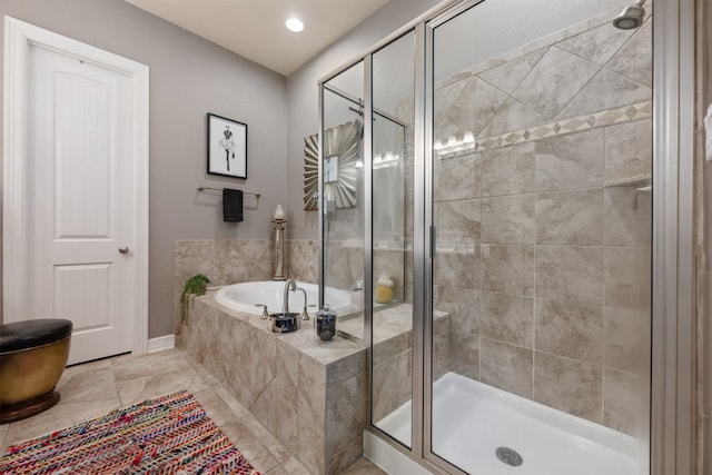 bathroom with independent shower and bath and tile patterned floors