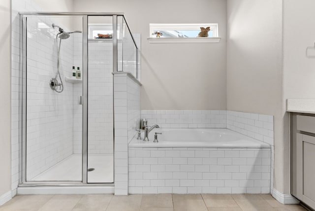 bathroom with tile patterned floors, vanity, independent shower and bath, and a wealth of natural light