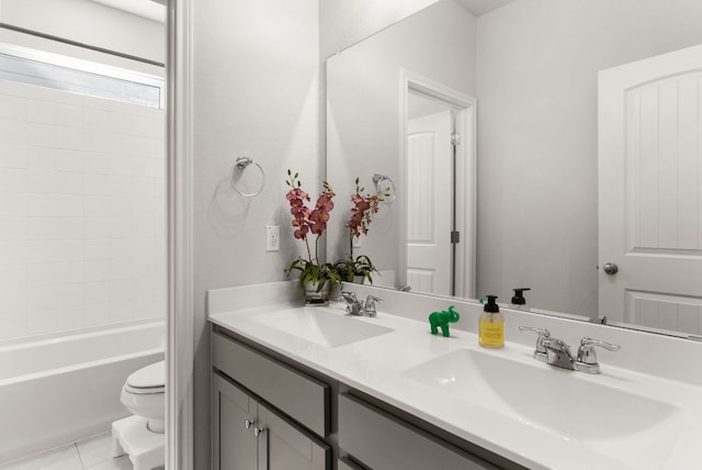 full bathroom featuring toilet, vanity, tile patterned floors, and  shower combination