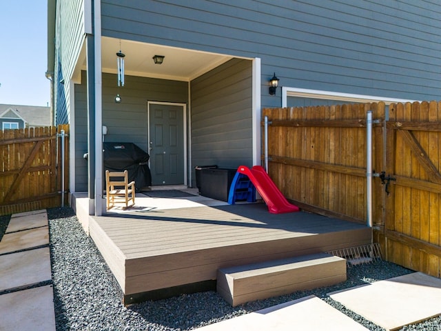 view of patio with grilling area and a wooden deck