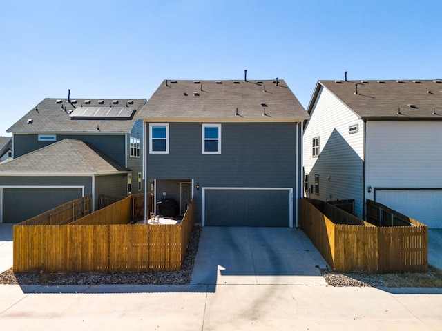 back of property with a garage