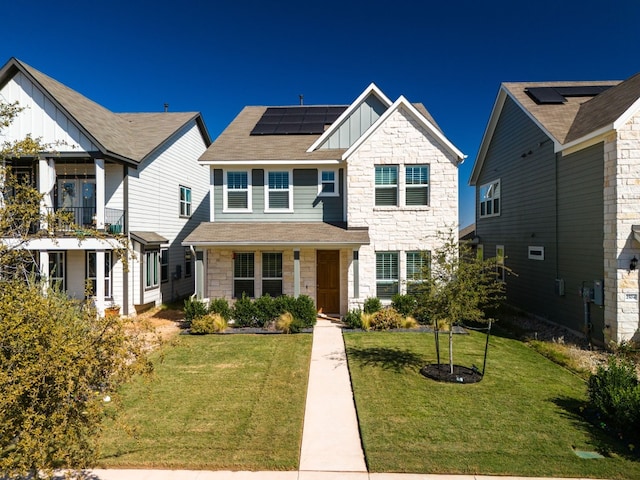 view of front of property with a front lawn and solar panels